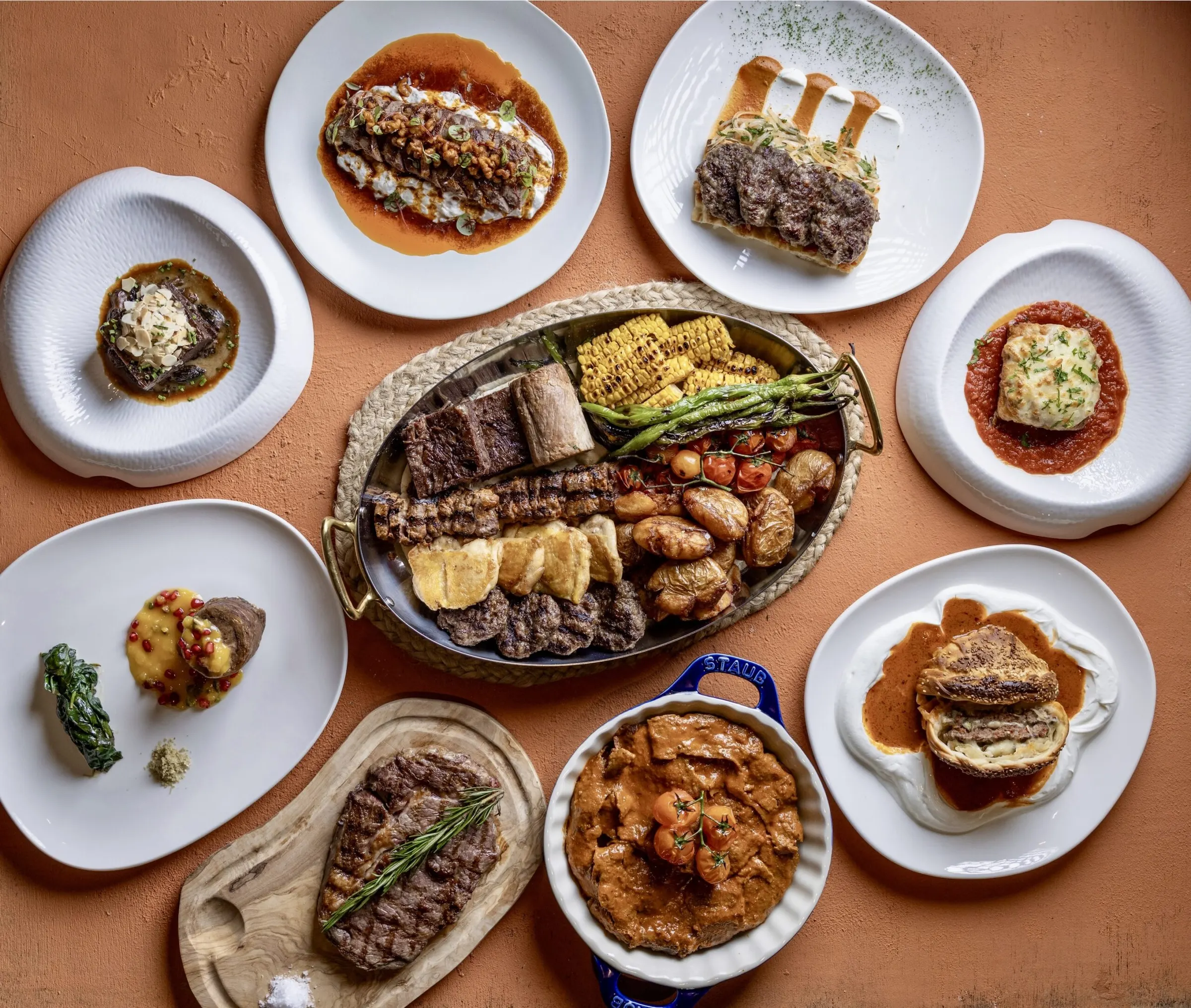 An overhead spread of grilled Turkish dishes at AVLU